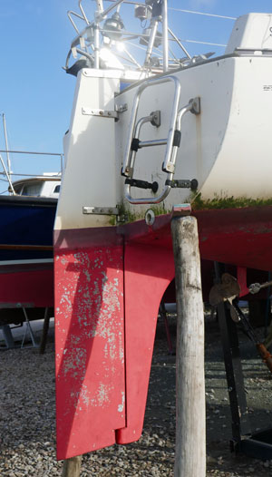 A transom-hung rudder with additional support provided by a full-length skeg.