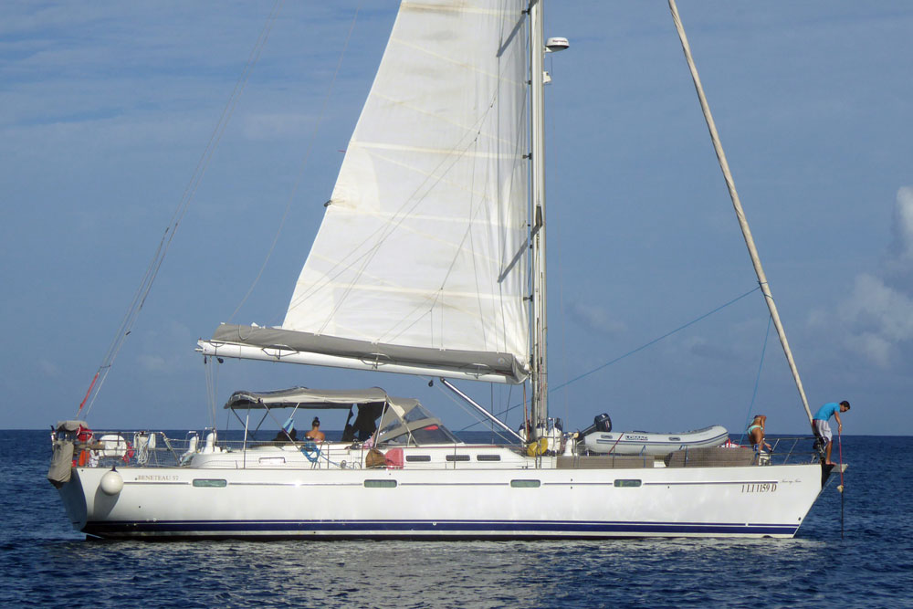 The crew of 'Never Say Never', a Beneteau 57 sailboat, drop the hook off Deshaies, Guadeloupe, an island in the French West Indies