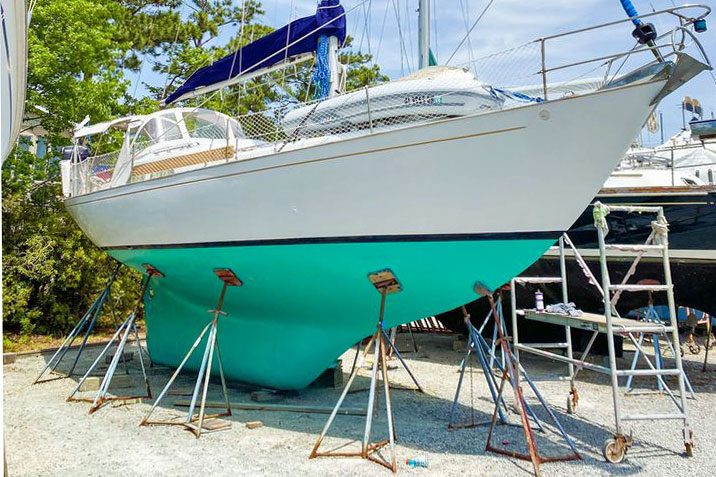 Long-keeled sailboat laid-up ashore