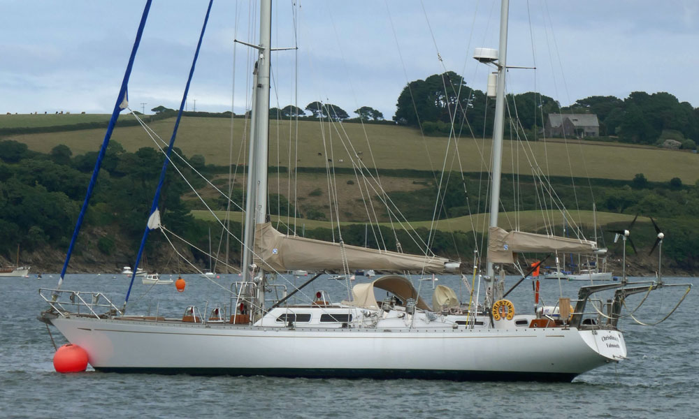 A Bowman 57 staysail ketch on a mooring ball in Cornwall's Helford River in the west of England