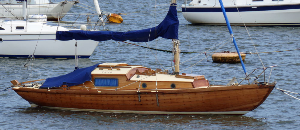 A wooden Folkboat 26 on a trot mooring.