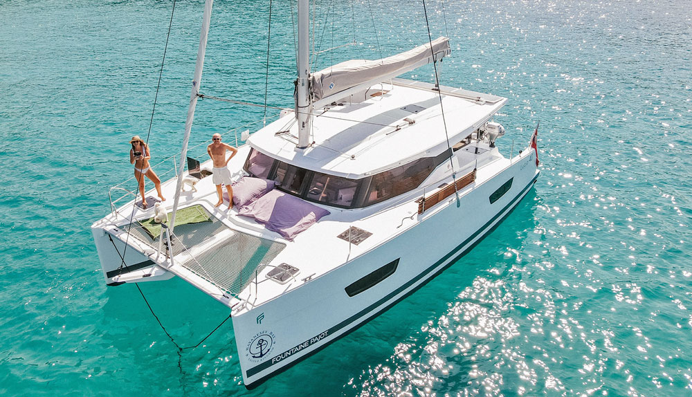 A Fountaine Pajot Lucia 40 Catamaran anchored in a clear sea