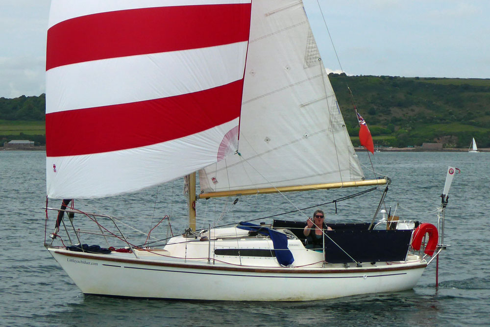 A Hurley 22 sailboat flying a cruising chute