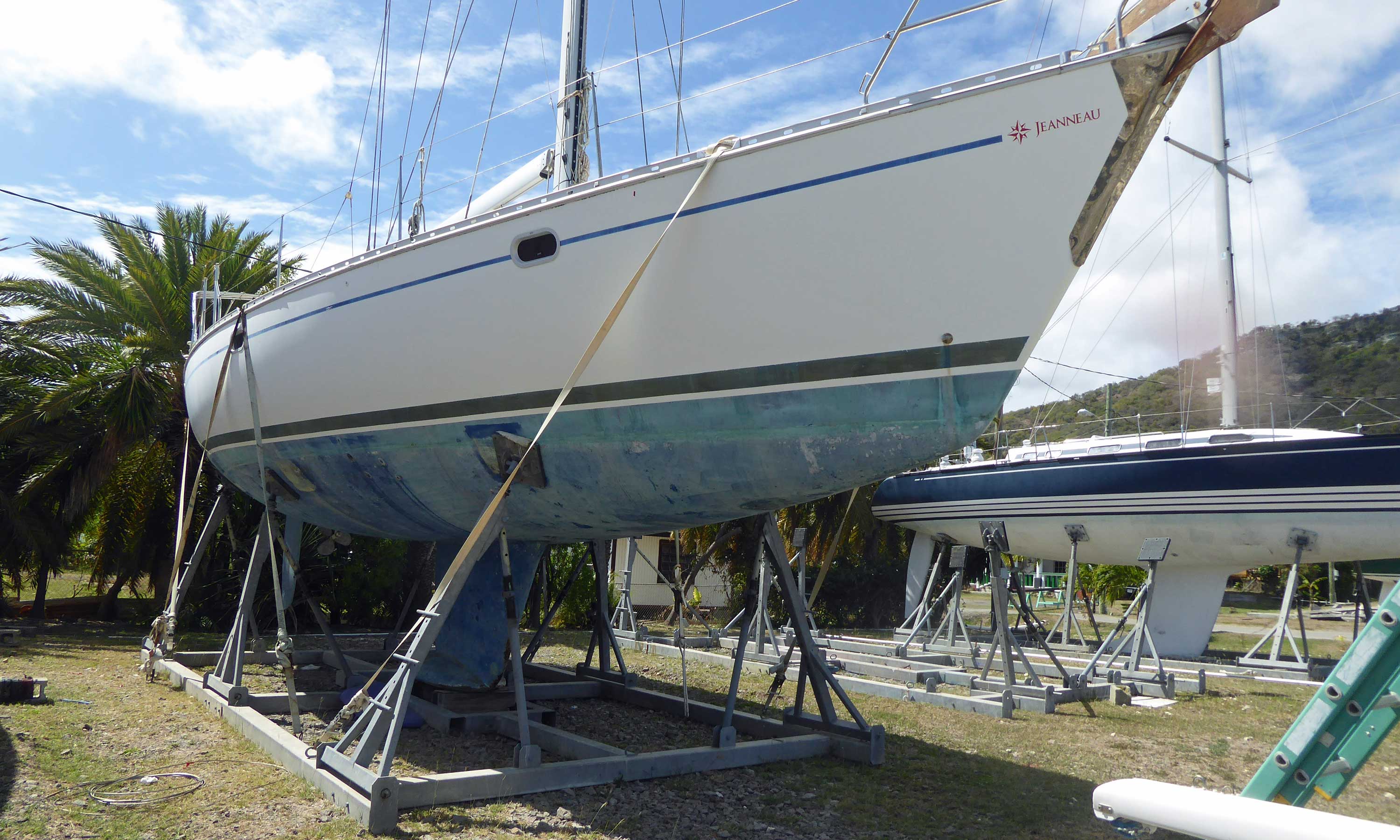 Sailboat safely laid up in a robust cradle, and tied down to ground anchors