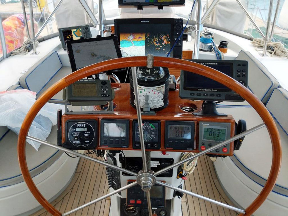 The helm position and navigational instrument cluster on an Irwin 54 sailboat
