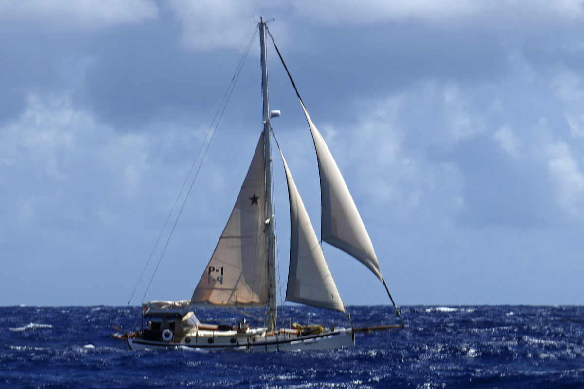 A Lyle Hess cutter reefed down in declining conditions