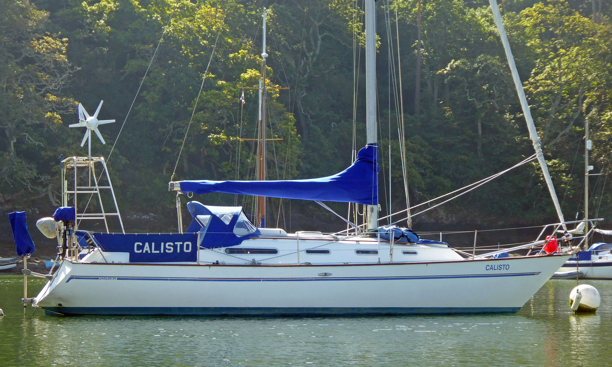 'Calisto', a Sadler 34 cruising yacht on a mooring ball on the River Yealm in Devon, UK