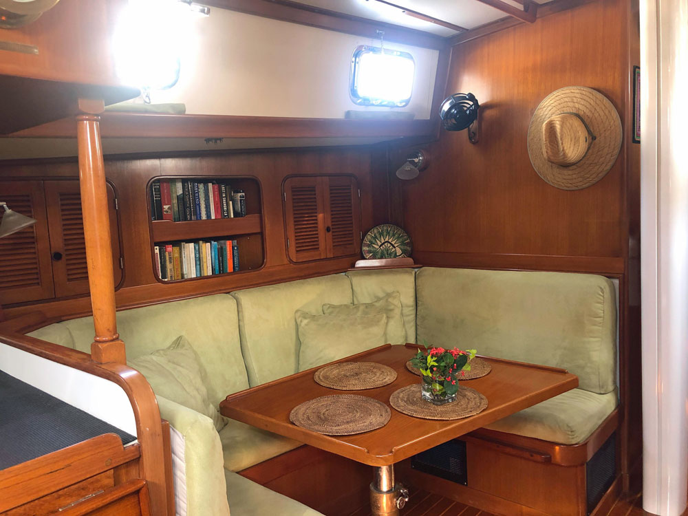 Mason 43 sailboat salon showing U-shaped dinette on port side