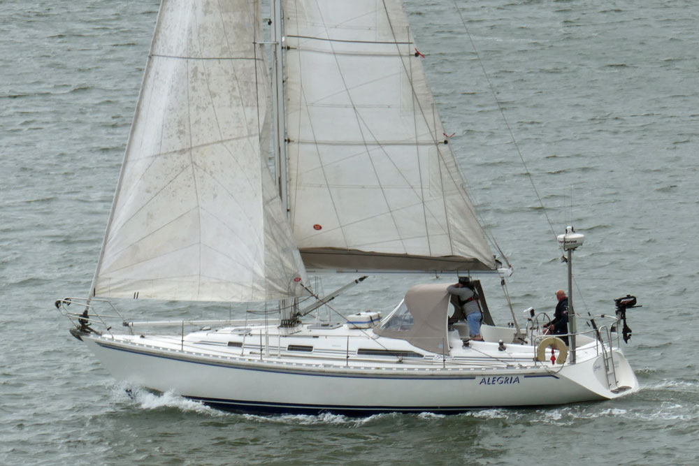 A Starlight 39 sailboat motor-sailing, with a back-winded headsail