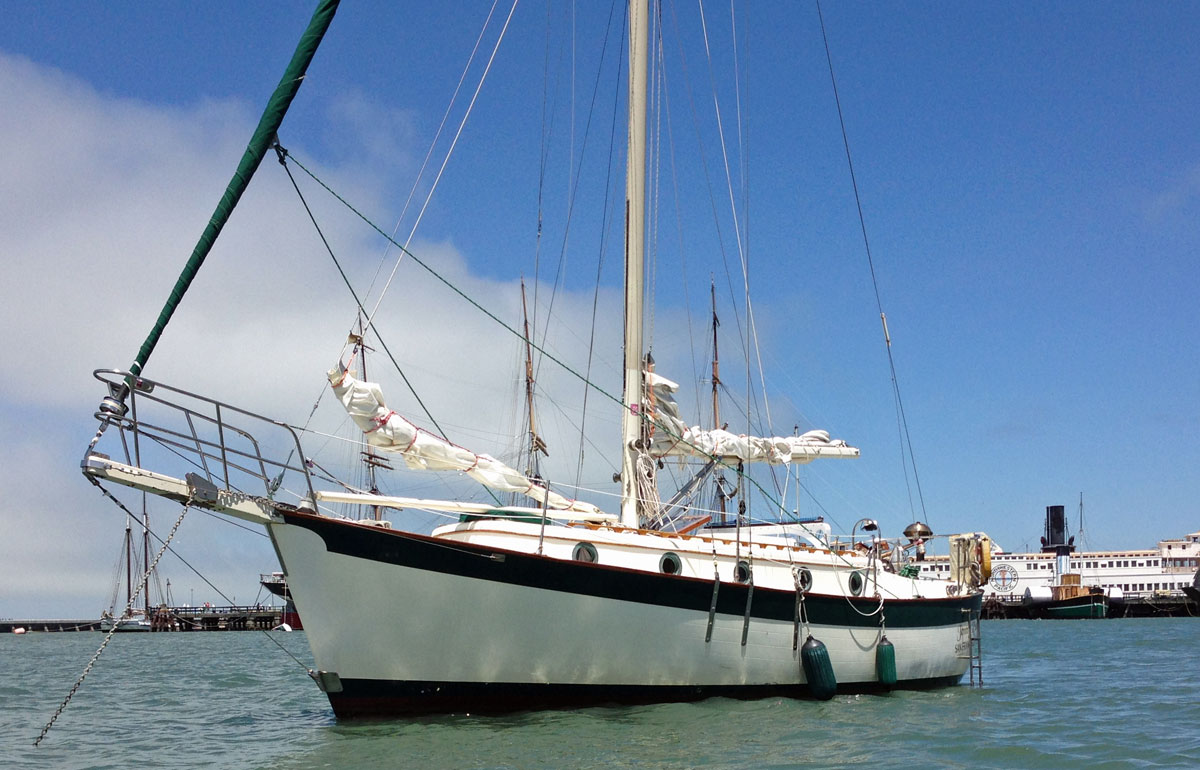 A cutter-rigged Willard 30 sailboat at anchor