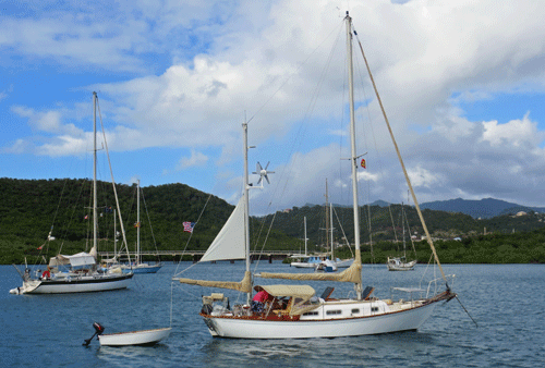 An Allied Seawind 30 cruising yacht flying a mizzen steadying sail at anchor in Hog Island, Grenada, West Indies