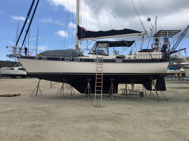 'Music II', a Morgan 41 Classic sailboat on tripod stands ashore in a boatyard