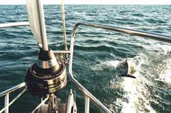 dolphin leaping ahead of a sailboat during a crossing of the Bay of Biscay