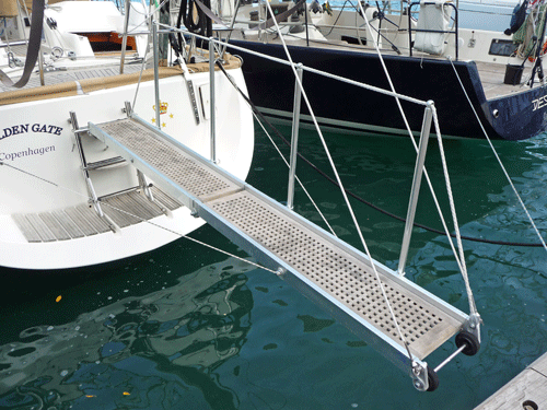 Sailboat stern-to the dock with a passarelle in position