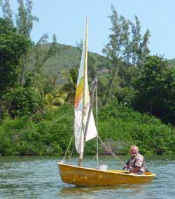 A rigid sailboat tender fitted with a sailing package