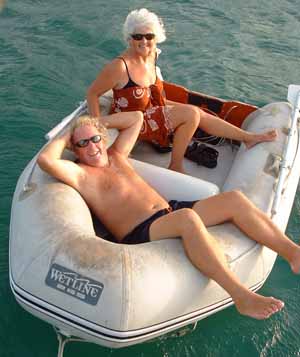 Sailing couple in dinghy