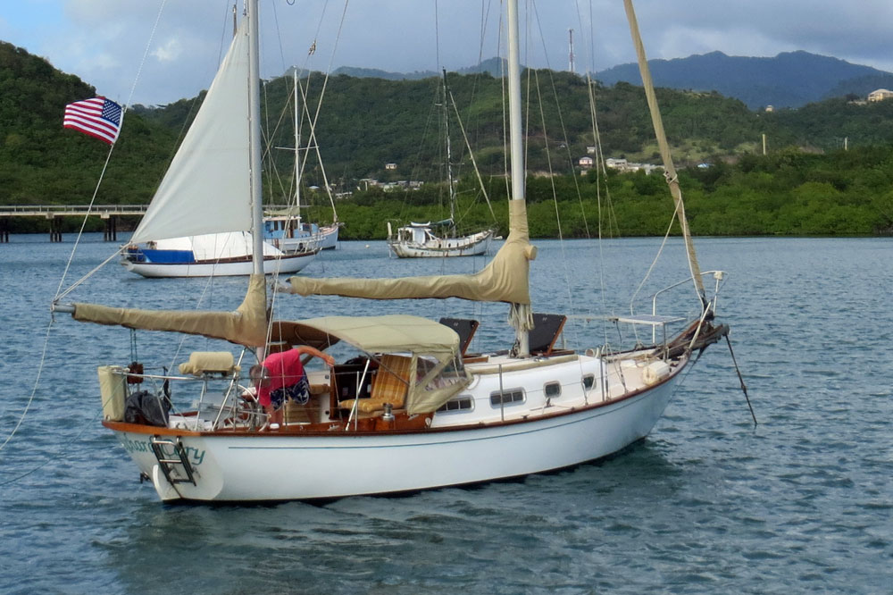 An Allied Seawind 30 ketch sailboat at anchor in Hog Island, Grenada, West Indies