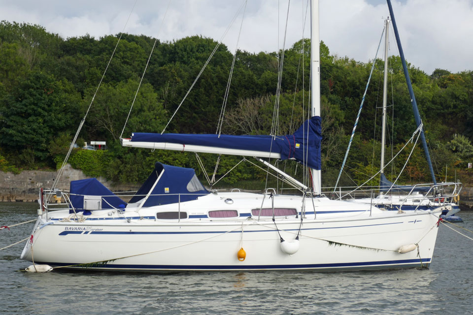A Bavaria 31 Cruiser sailboat moored on the River Tamar in southwest England