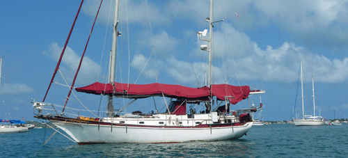 A full-size deck awning on this anchored sailboat.