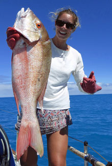 Diggy with a red snapper caught from a sailboat underway