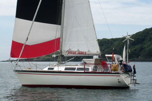 A Dufour 29 sailboat launches the spinnaker