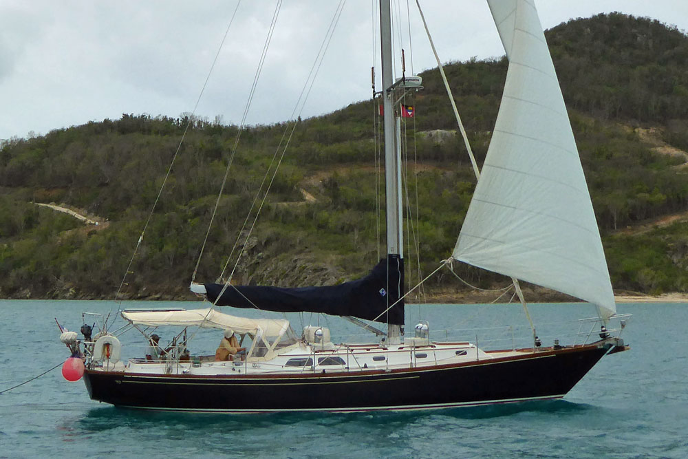 A Hinckley Sou'wester 42 sailboat enters the Jolly Harbour anchorage under headsail in Antigua, West Indies.