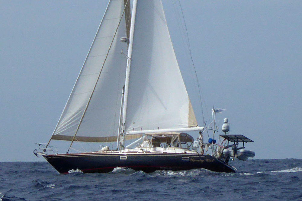 A Hunter 49 sailboat powers to windward under a full main and reefed headsail