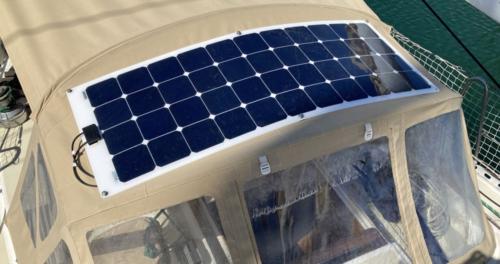 A flexible solar panel on the dodger of a J/40 sailboat