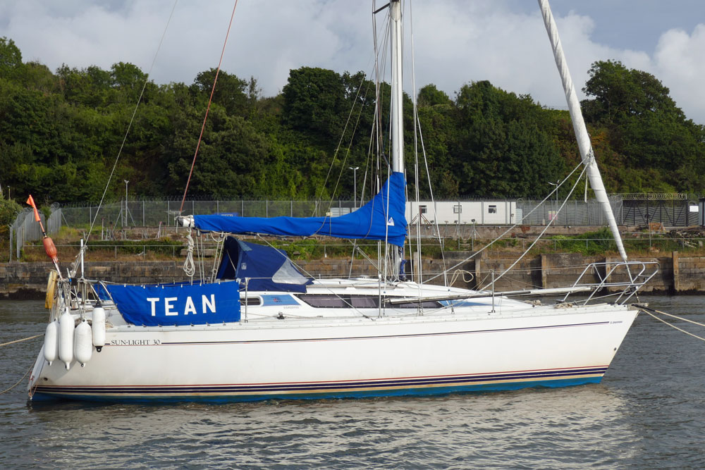 A Jeanneau Sun Light 30 sailboat moored on the River Tamar in southwest England