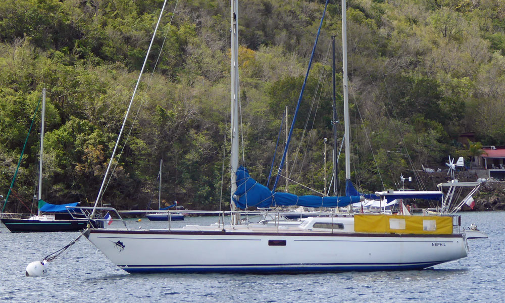 A Jouet 1300 sailboat on a mooring ball in Grande Anse d'Arlet, Martinique, in the French West Indies