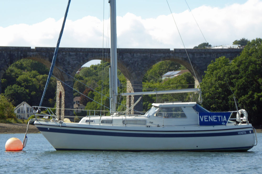 An LM 30 sailboat moored off in the Tamar off Saltash, Cornwall in England