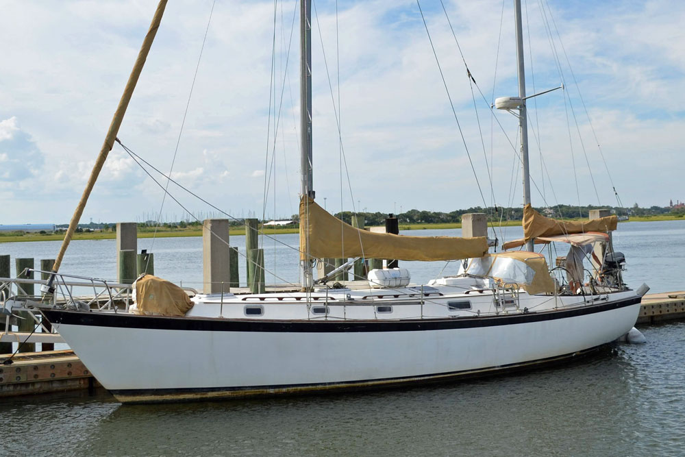 A Pearson 424 ketch alongside a dock.