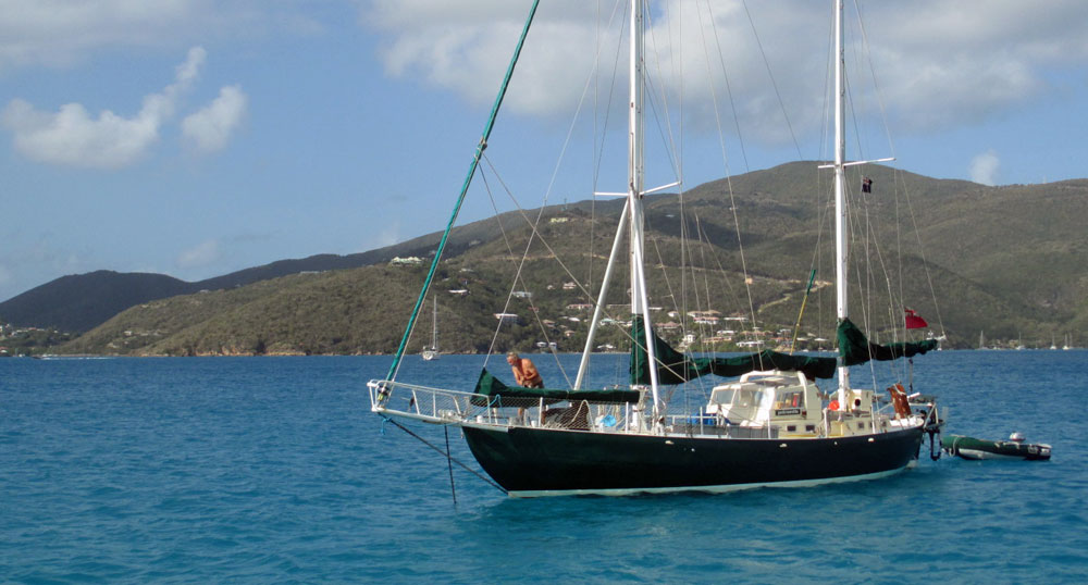 A sailboat anchoring off Vixen Point in the Caribbean island of Virgin Gorda