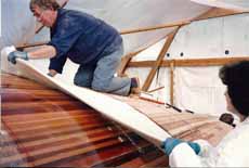 sheathing the hull of a wood-epoxy sailboat with woven glass rovings