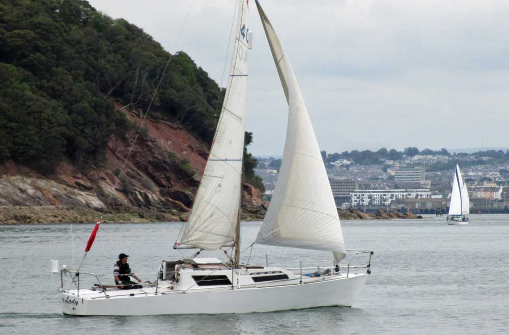 A Royal Cape One Design sailboat approaching Plymouth, UK