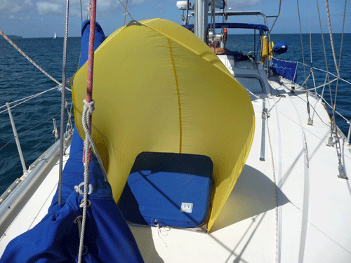 Our home-made wind scoop over Alacazam's foredeck hatch